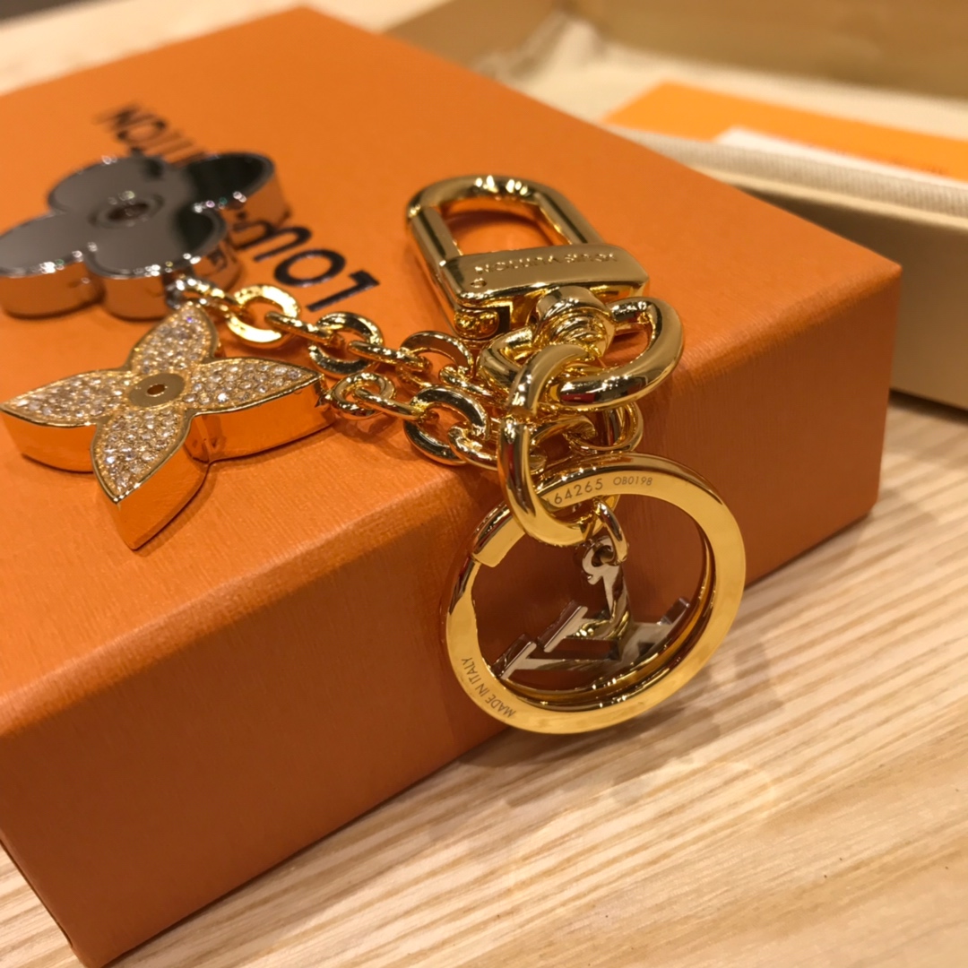 Detailed shot of the flower keychain, showing metal and crystal quality.
