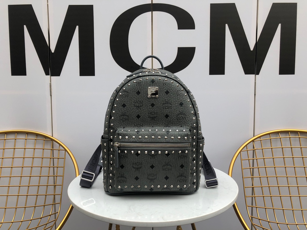 Top-tier Stark backpack from the Nail series, designed for durability and iconic style. Featuring rivet detailing and brass logo plate, with leather accents. Functional with adjustable straps, durable zippers, multiple pockets, and padded compartments for electronic devices. A timeless streetwear essential. Size: Small - 26cm width, 33cm height, 15cm depth. image 1