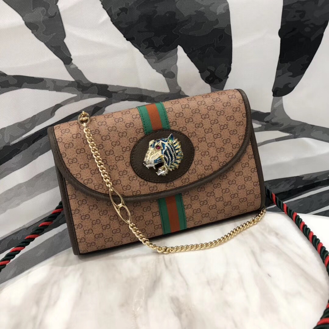 # New Rajah Series #
Model: Top-grade original 570145  
Size: 24*16*5 cm  
2019 Spring/Summer new member of the Rajah series. Made of synthetic leather with embossed double G logo. The leather V-shoulder bag features the series' signature colorful enamel and crystal tiger head design, adorned with crystals. Inspired by jewelry fashion design, the development of this tiger head was particularly challenging. Dual strap design includes one chain strap and one detachable brand signature red-green webbing strap.  
Model number: 556068 image 1