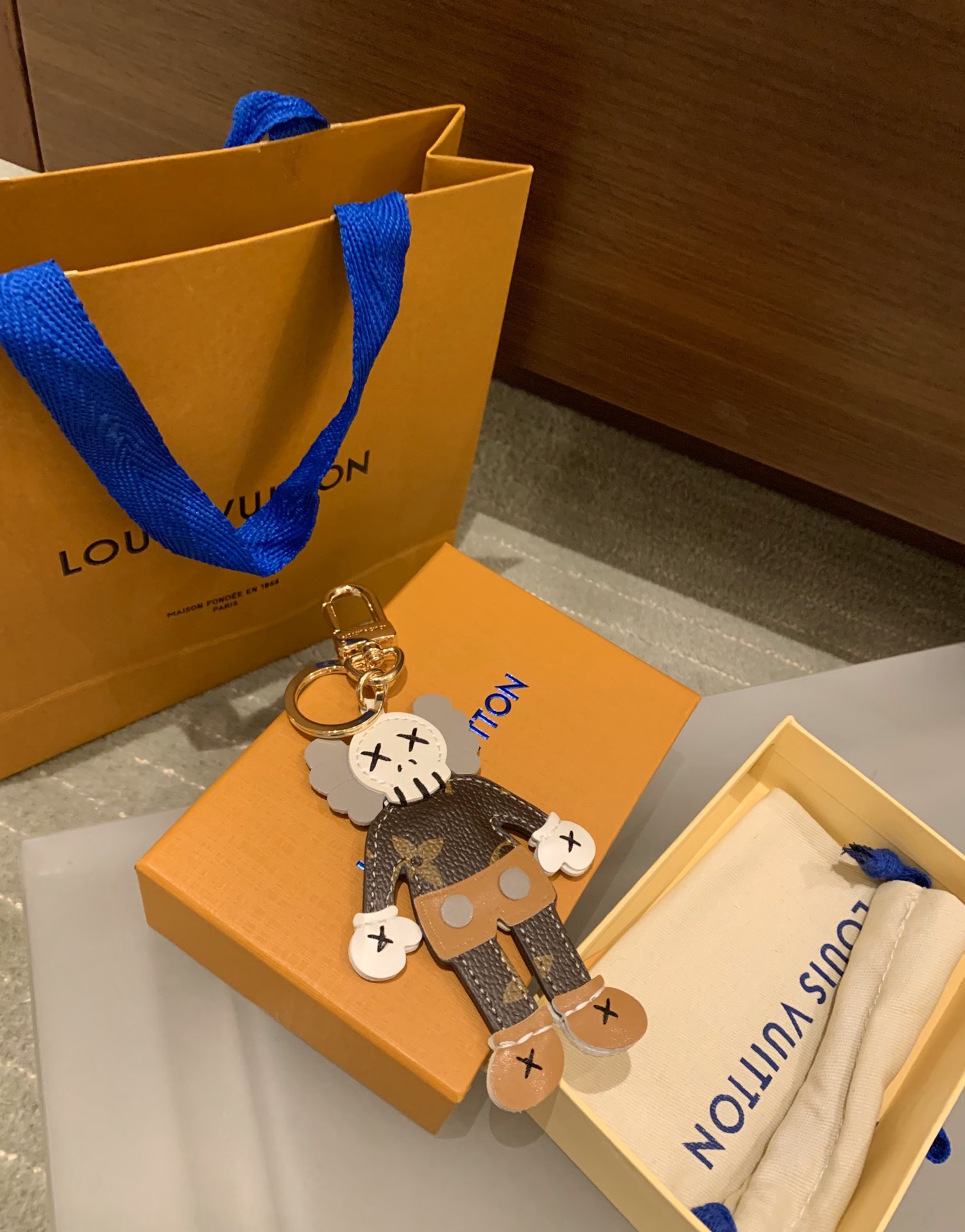 Close-up of KAWS leather keychain