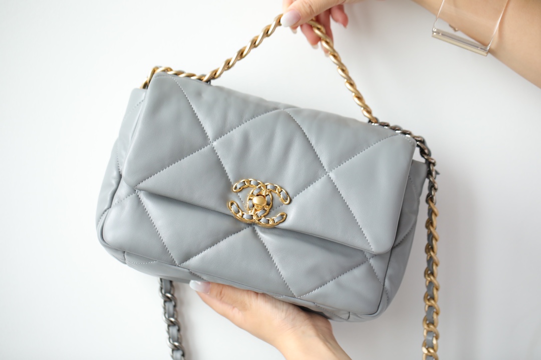 Chanel 19 Flap Bag in grey, made of lightweight and soft goat leather with large diamond quilting design. Material: Exclusive C Factory ZP leather. Hardware: 24K gold-plated vintage buckle. Can be worn three ways: crossbody, single shoulder, hand carry. Chain strap available in vintage gold, vintage silver, and shiny silver. Size: 16*26*9cm (small size). image 1
