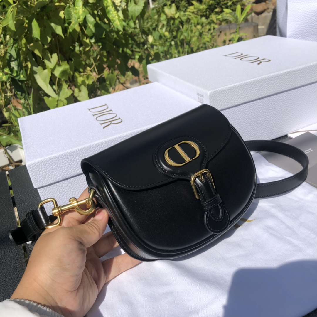 La firme forma del bolso en forma de media luna, el clásico logotipo "CD" y la dirección del taller Dior "30 MONTAIGNE"…