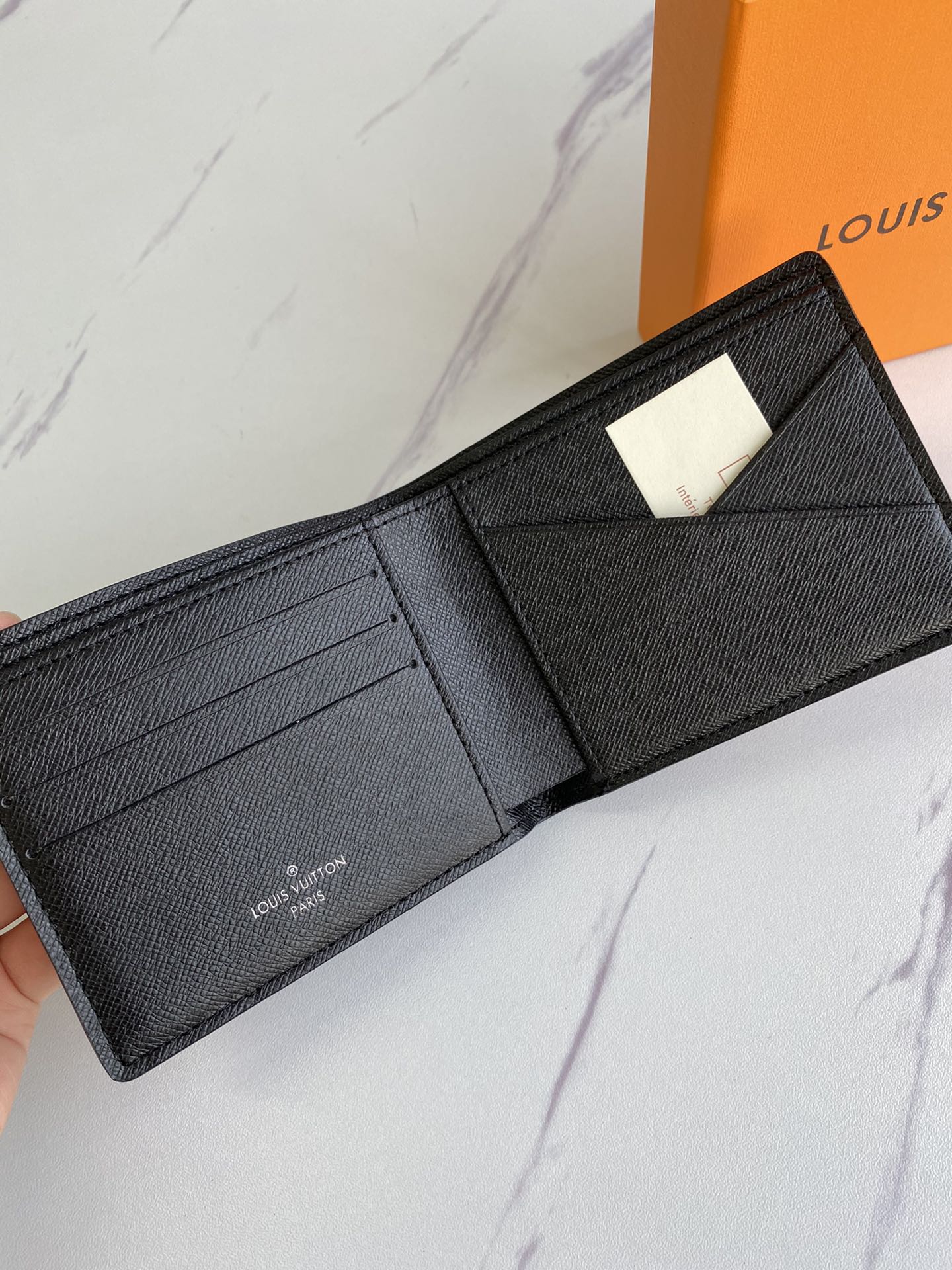 Close-up of the stitching on a leather bifold wallet