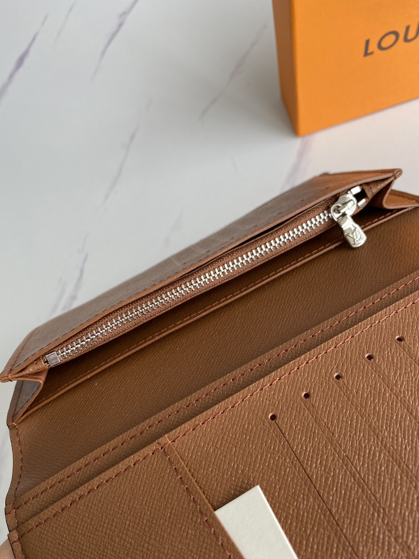 Leather bifold wallet being used in a real-world setting.