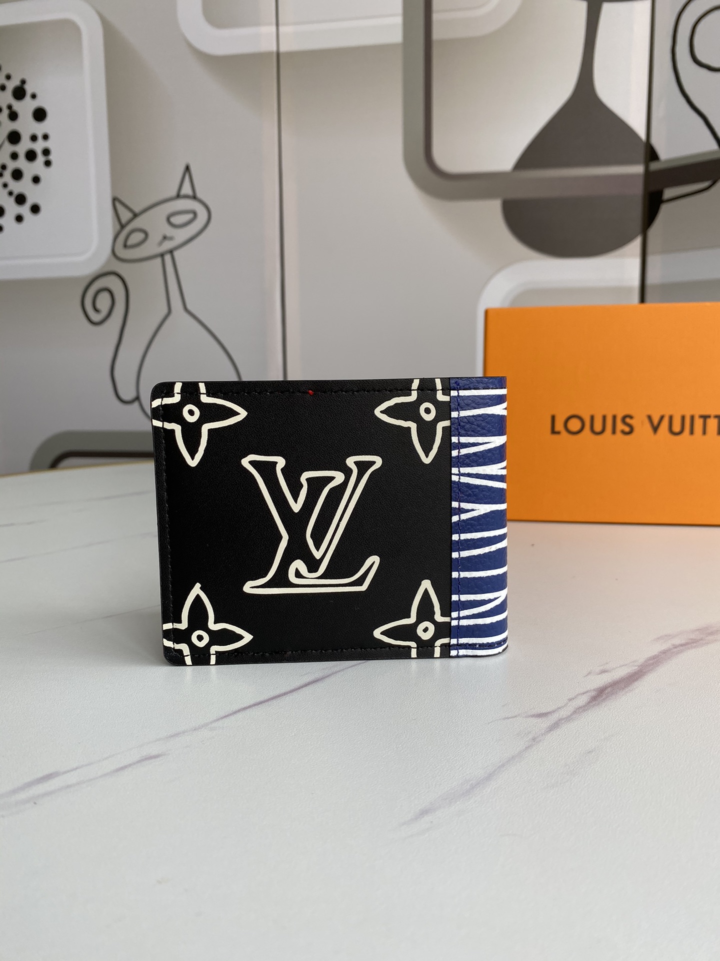 Black leather bifold wallet open revealing card slots and bill compartment