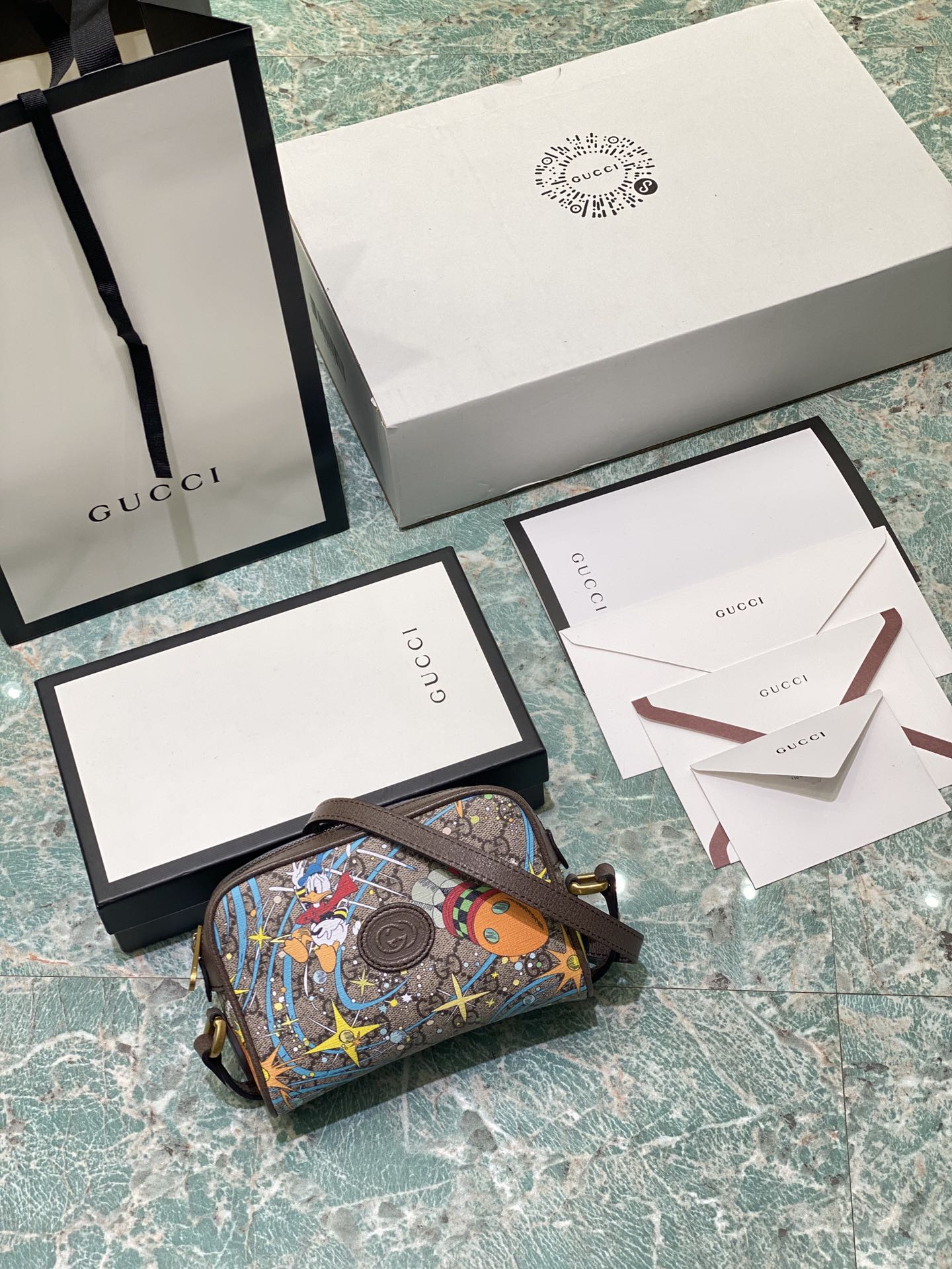 Disney animated characters continue to inspire the brand’s aesthetic. The adorable Donald Duck adds a whimsical touch to classic designs, blending fashion with a playful spirit. Premium original.  
Model: 648124  
Size: W17.5 x H12 x D5.5 cm  
Color/Material: Brown PVC / Donald Duck design image 1