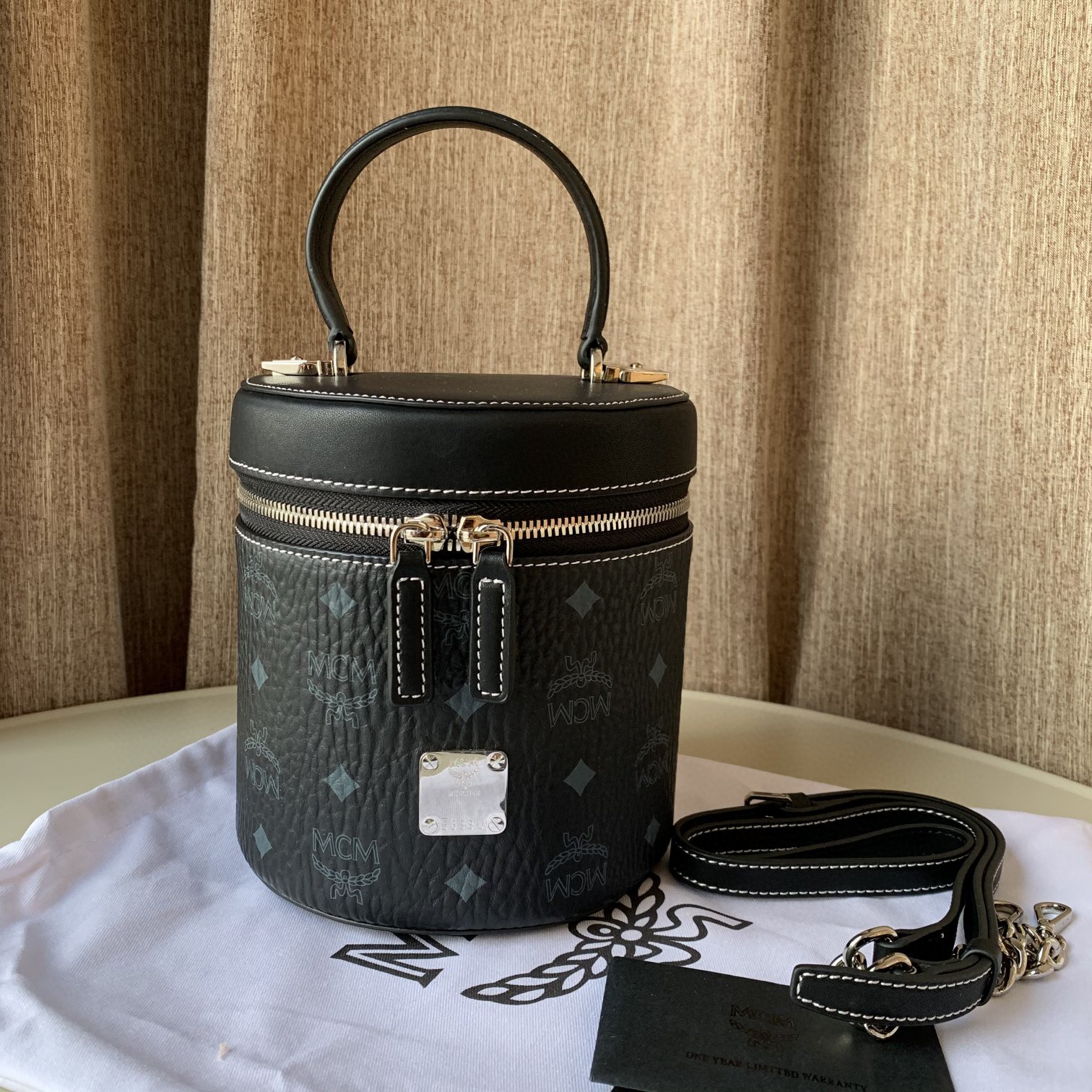 Top quality item 💐【Top MCM Cylinder Bag】This small crossbody bag features a geometric shape that is enhanced by the classic Visetos pattern print and gold-plated logo, showcasing the brand's iconic symbols. Made of French Nappa leather with a double zipper closure, the bag has a spacious interior lined with fabric to store your valuables. This cylindrical crossbody bag can be carried by the top leather handle or with the included shoulder strap for added convenience. Dimensions: 16.0 x 16.0 x 14.0 cm. Shoulder strap length is adjustable from 98 to 114 cm. image 1