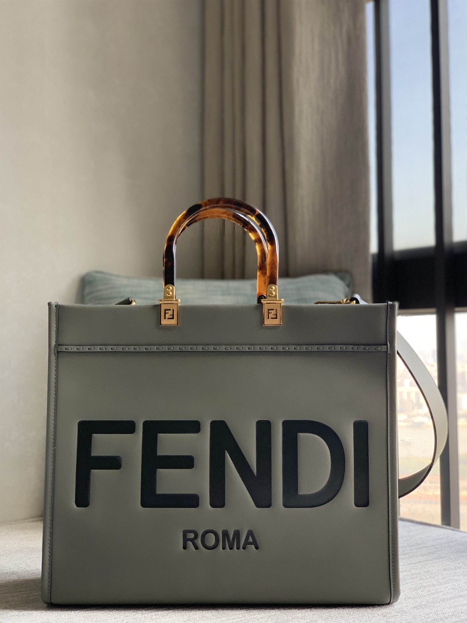 Fendi Sunshine tote bag, medium gray full calfskin, decorated with hot-stamped "FENDI ROMA" pattern. Featuring spacious Alcantara-lined interior