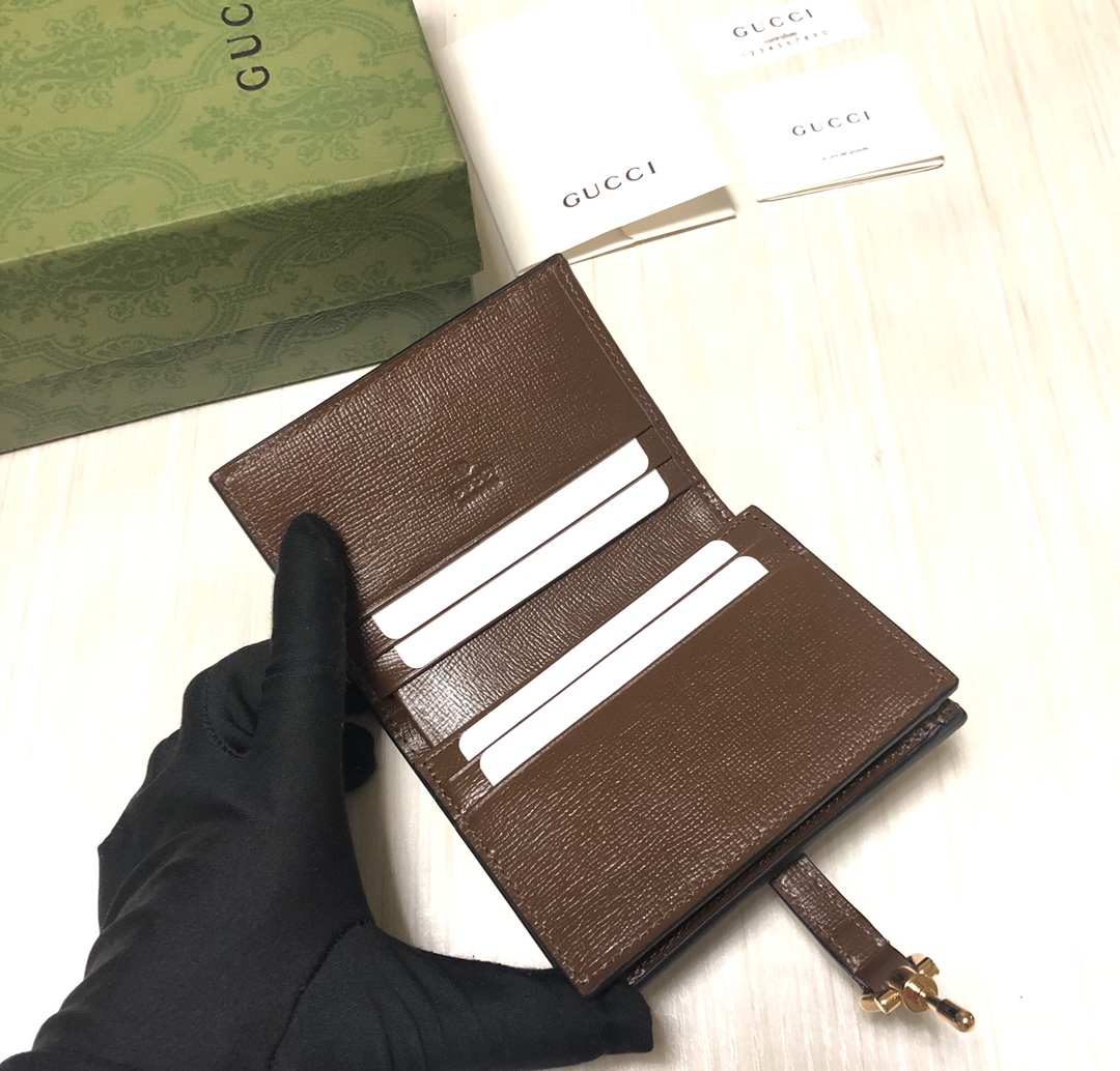 Jackie 1961系列借鉴手袋设计灵感，推出小巧高贵的全新小卡包。金色调推入式锁扣细节令人联想起19