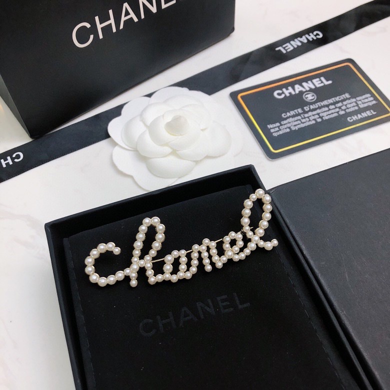 chanel crystal script logo brooch