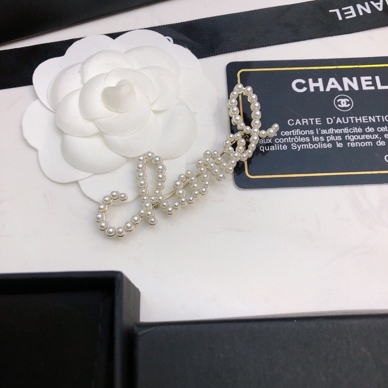 chanel crystal script logo brooch