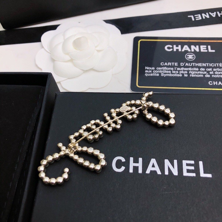 chanel crystal script logo brooch