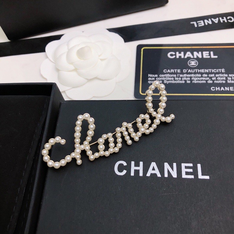 chanel crystal script logo brooch