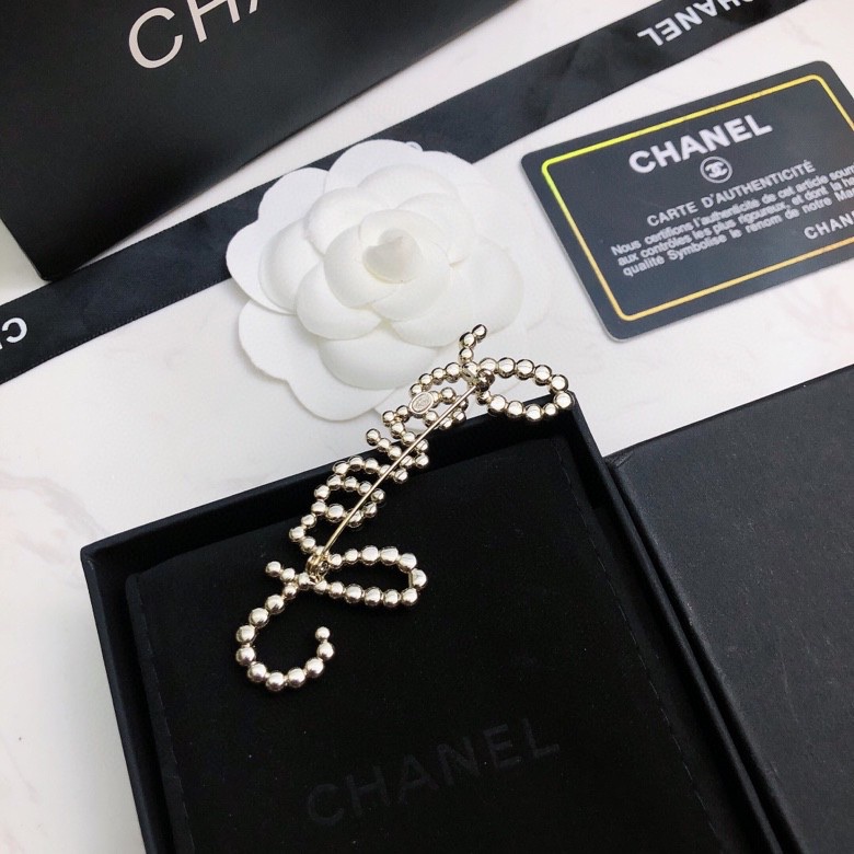 chanel crystal script logo brooch