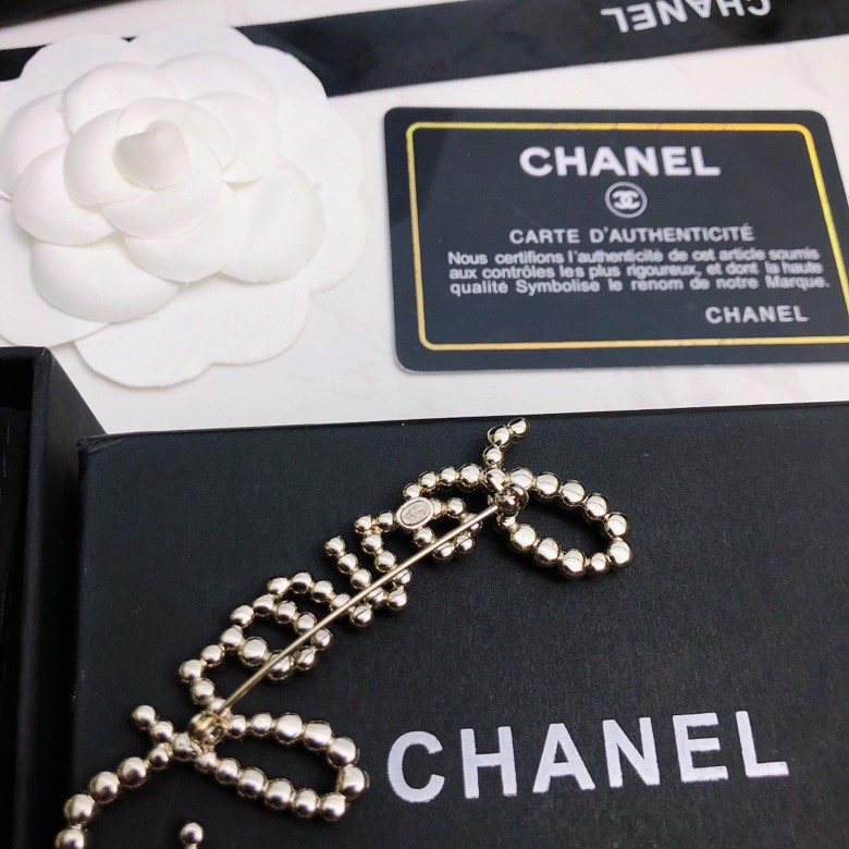 chanel crystal script logo brooch