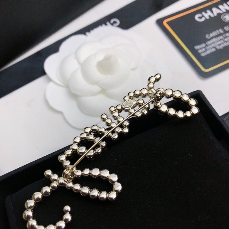 chanel crystal script logo brooch