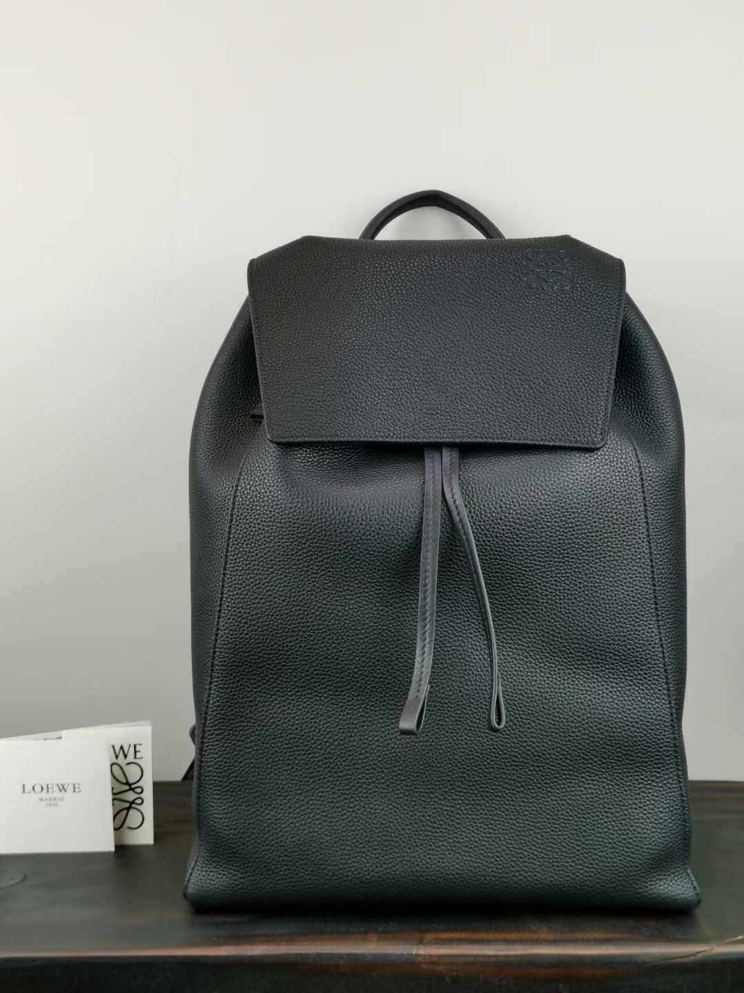 Loewe 2021 grained calfskin drawstring backpack, crafted with a large area of calfskin to exude a bold and rebellious vibe. Model 329140, a practical backpack featuring a drawstring closure, additional front flap, and a clasp. Can be worn as a backpack, shoulder bag, or crossbody with adjustable calfskin straps. Includes an interior slip pocket, suede lining, Anagram embossing. Dimensions: 41-31-24. image 1