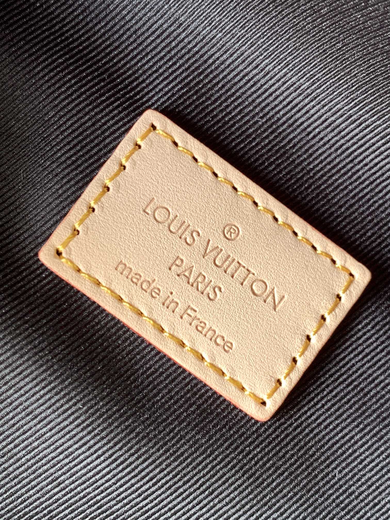 Crafted from classic Monogram canvas and accented with a "Louis Vuitton - Bag 9