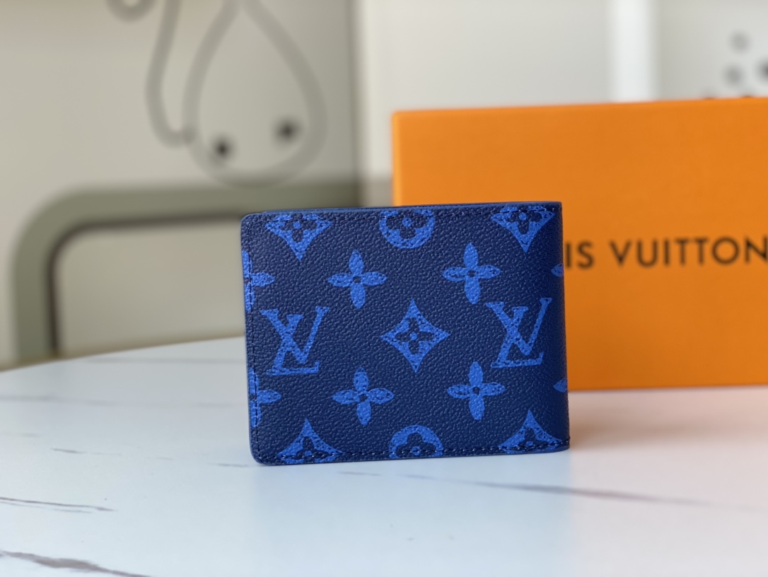 Open view of a bifold leather wallet, showing card slots and cash compartment