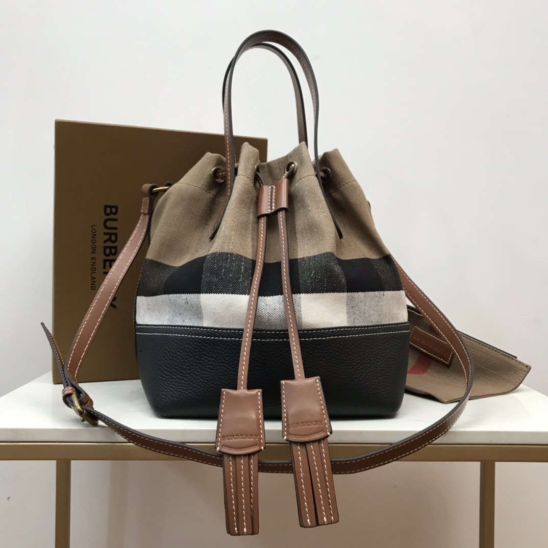 Burberry's durable Canvas original bucket bag with leather fringe detail. The top leather handle and shoulder strap allow it to be worn on the sh