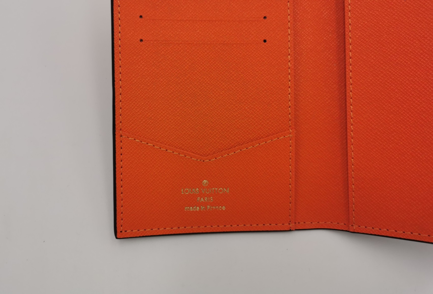 A person holding the slim passport wallet