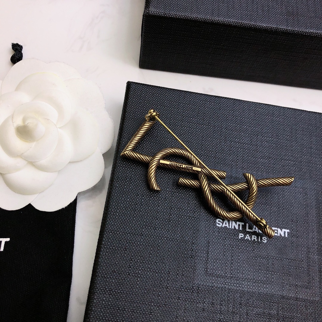 Saint Laurent Cassandre Twisted Monogram Brooch brooch antique brass gold metal no gemstones 4 5cm width
