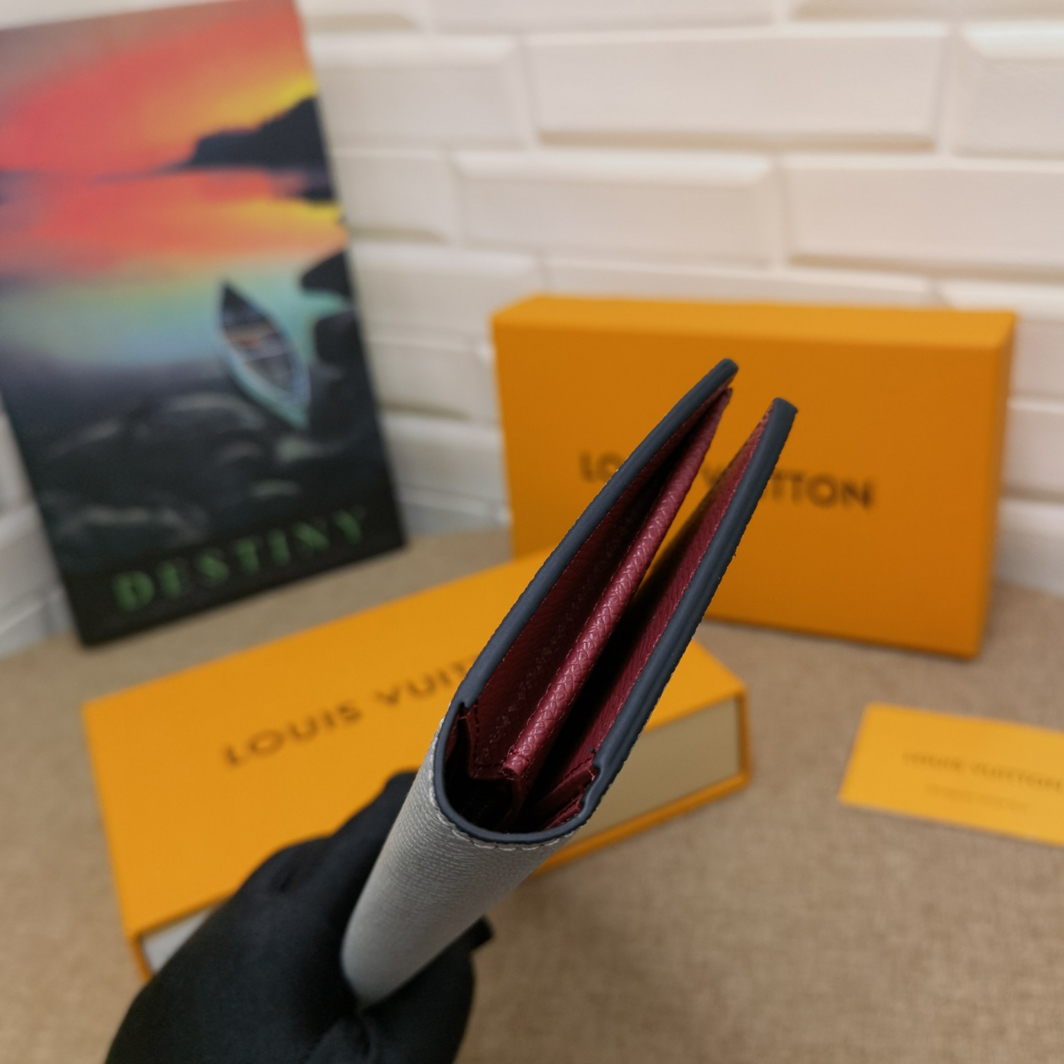 Person holding a leather bifold wallet in their hand