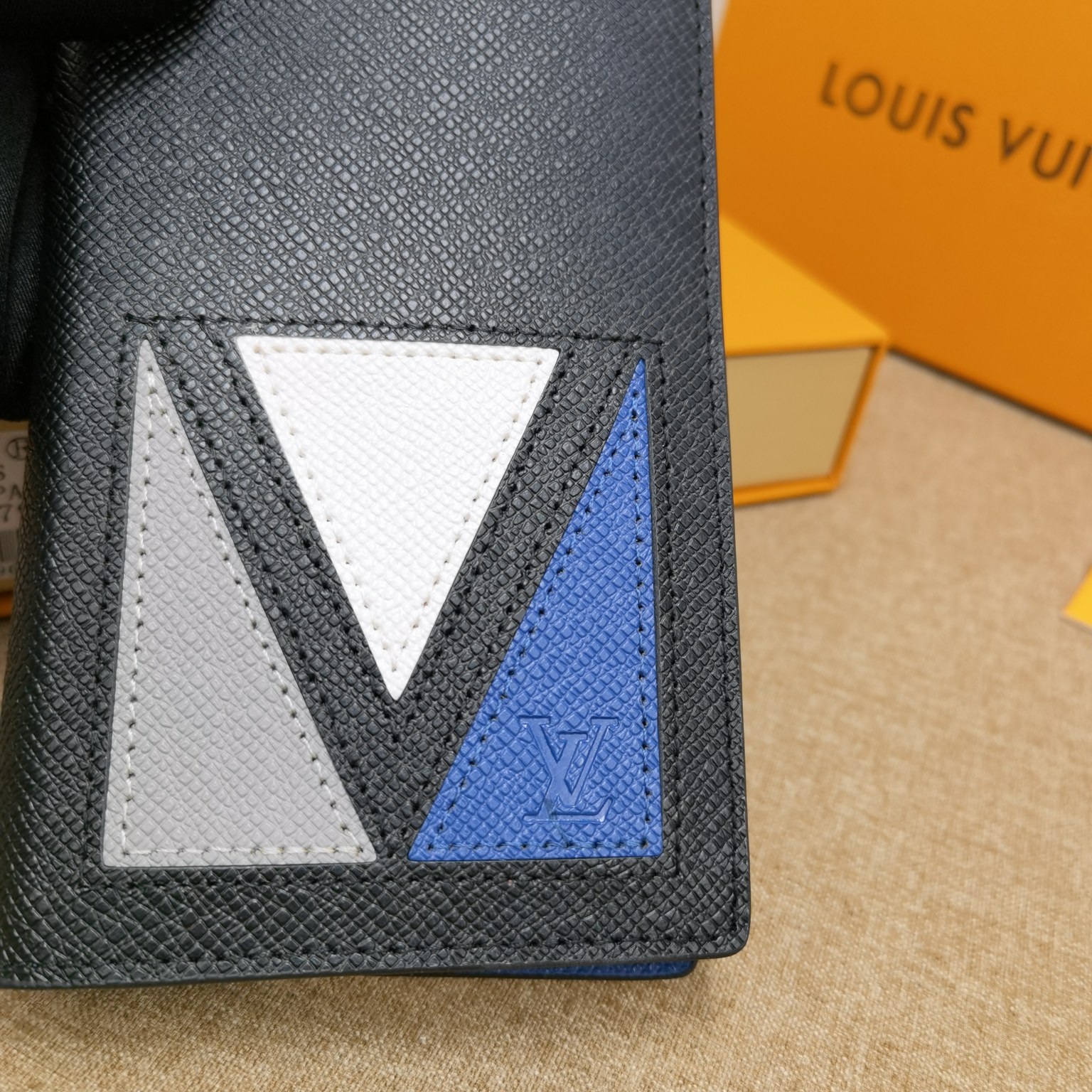 Person holding a minimalist leather bifold wallet in their hand