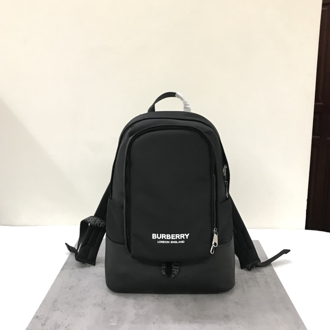 The Burberry backpack is crafted from ECONYL fabric and has a topstitched leather base. It has multiple pockets and a laptop compartment, creatin