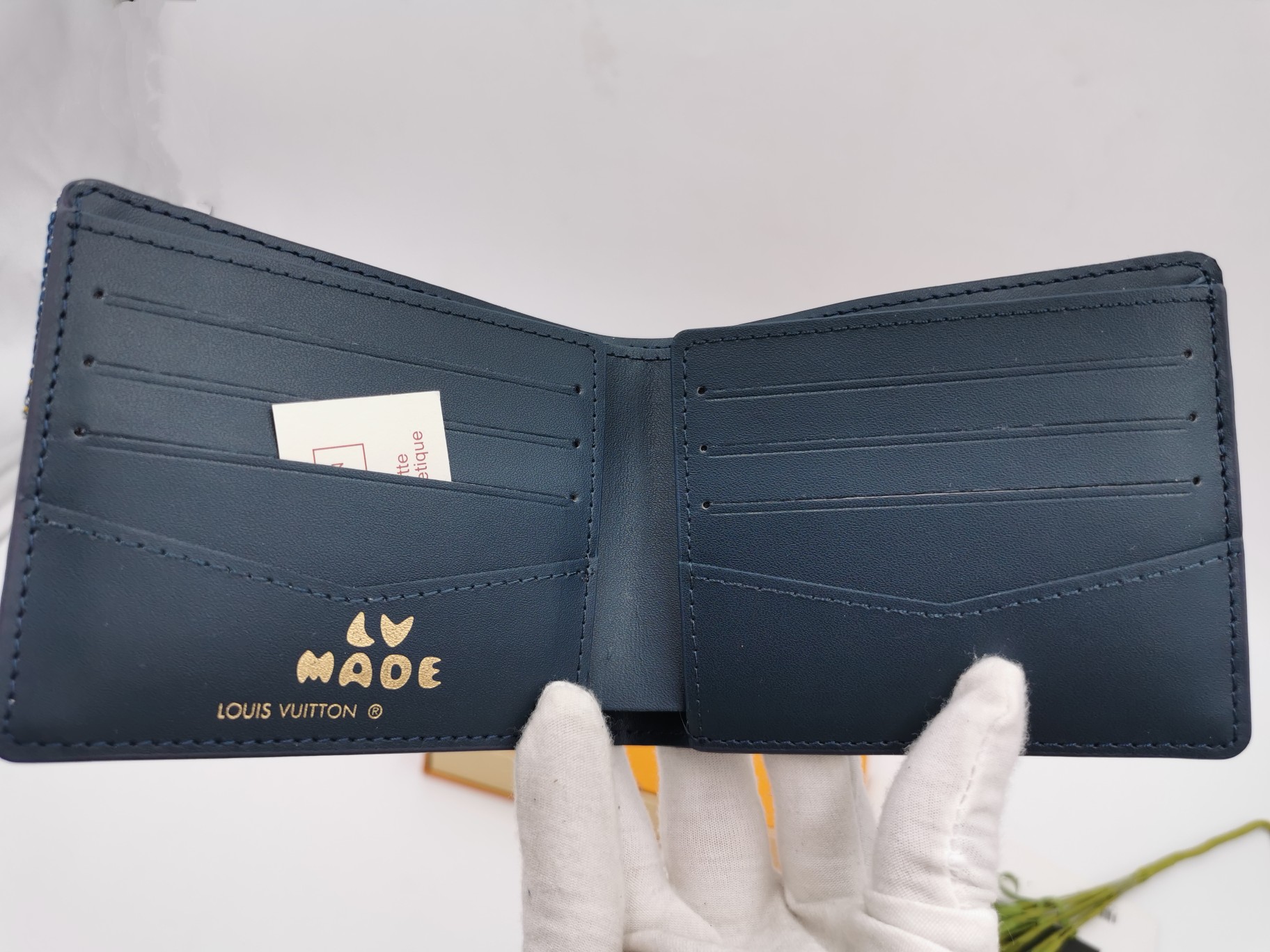 A person holding the luxury leather bifold wallet.