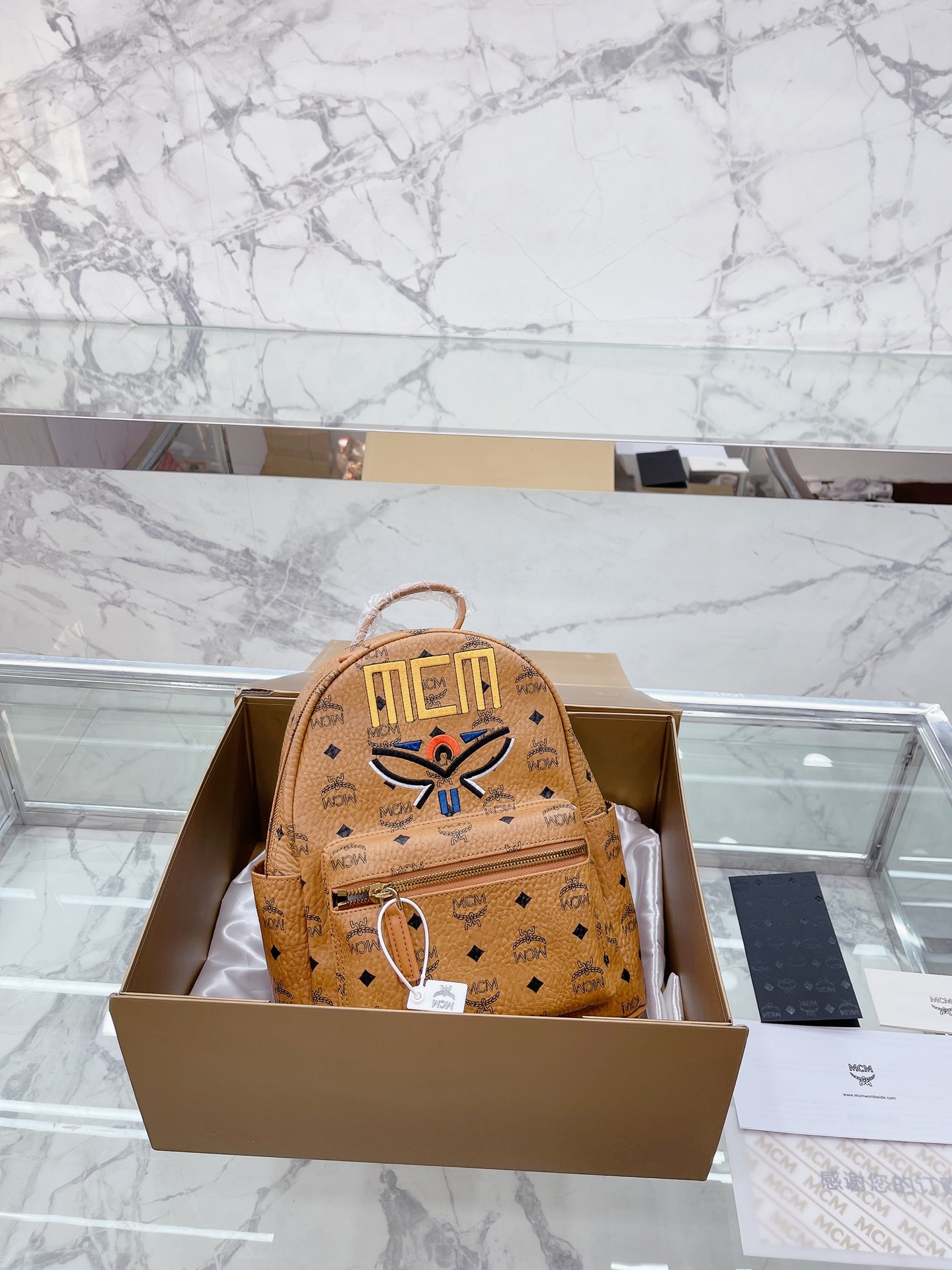 牛皮 全套礼盒包装 MCM STARK Visetos月桂叶刺绣女包双肩包背包 经典的MCM双肩包型 手工3D立体刺绣的 Logo和月桂叶图案，采用红黑蓝三 色设计，寓意天空大地和红花，体现品牌对保护地球 我和实现可持续化发展的不断探求。 结构化设计使其拥有宽敞的内部空间 尺寸大小：27 32cm