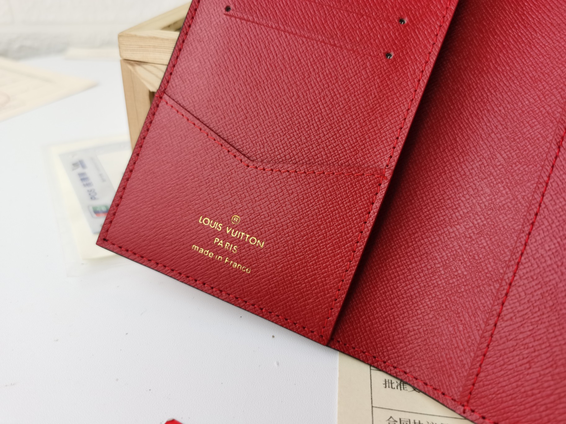 Person holding a passport cover.