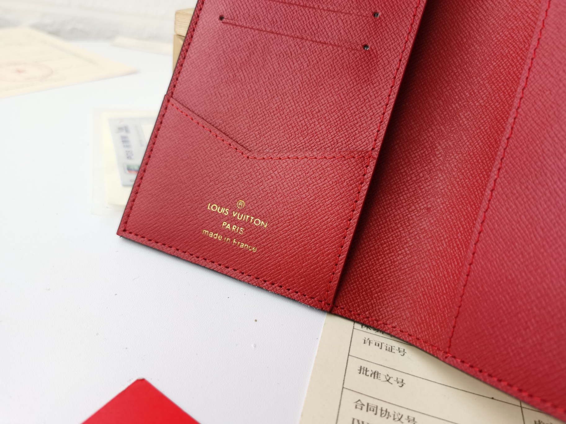 A person holding the passport case.