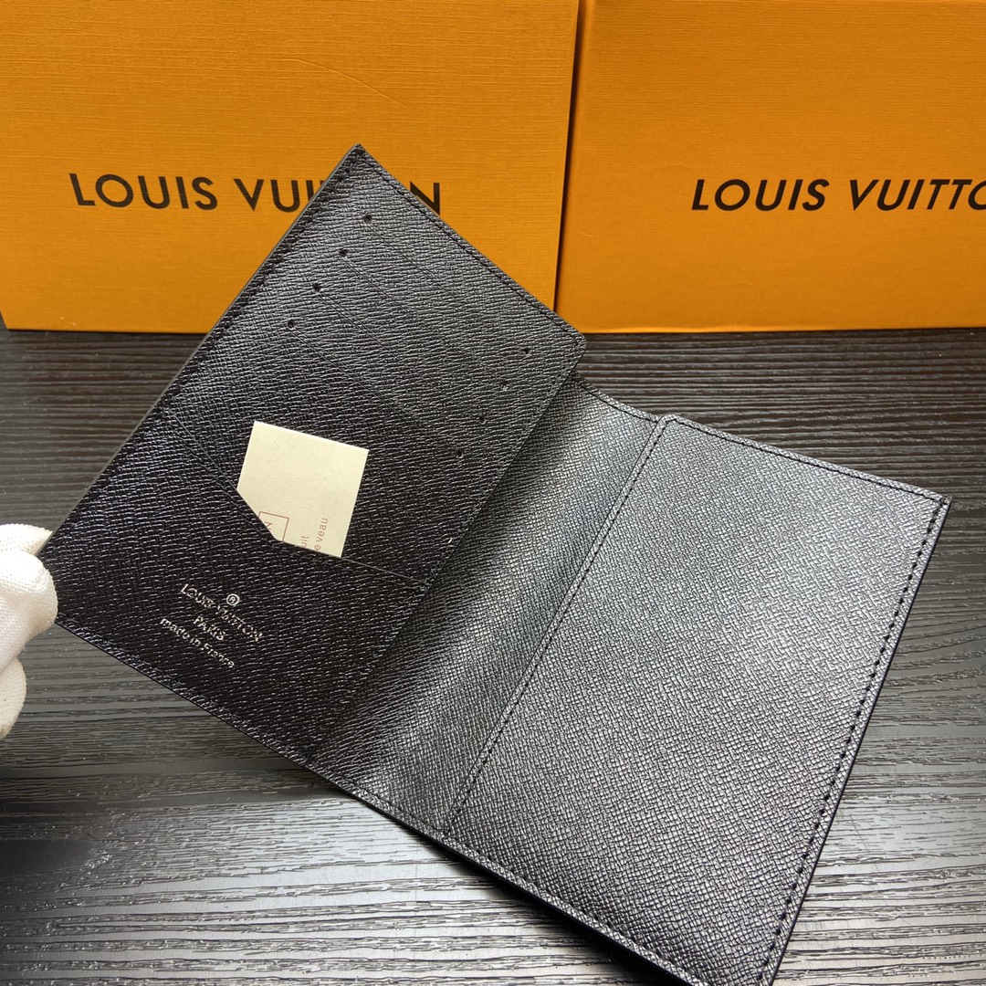 Passport wallet in use, held in a hand.