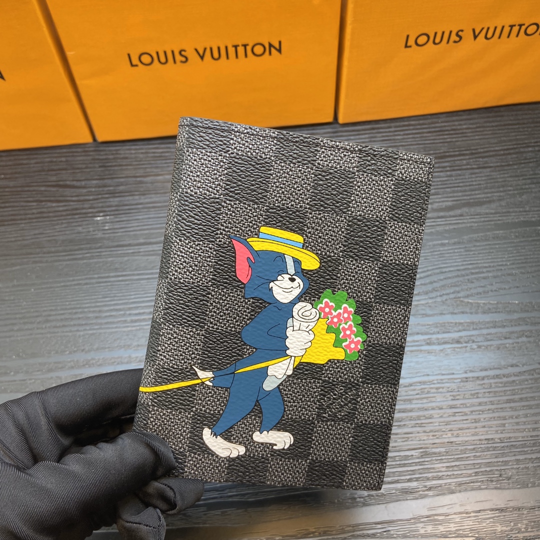 Person holding a leather passport holder