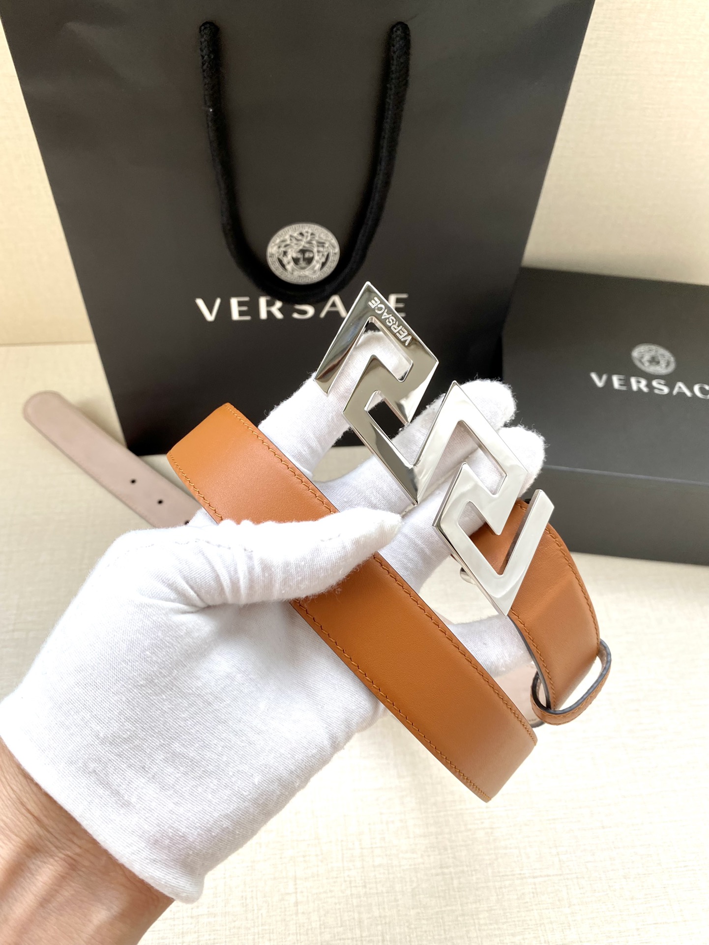  VERSACE 宽度3.0cm 此款腰带由优质皮革制成，饰有La Greca彰显个性设计。该铆钉腰带饰