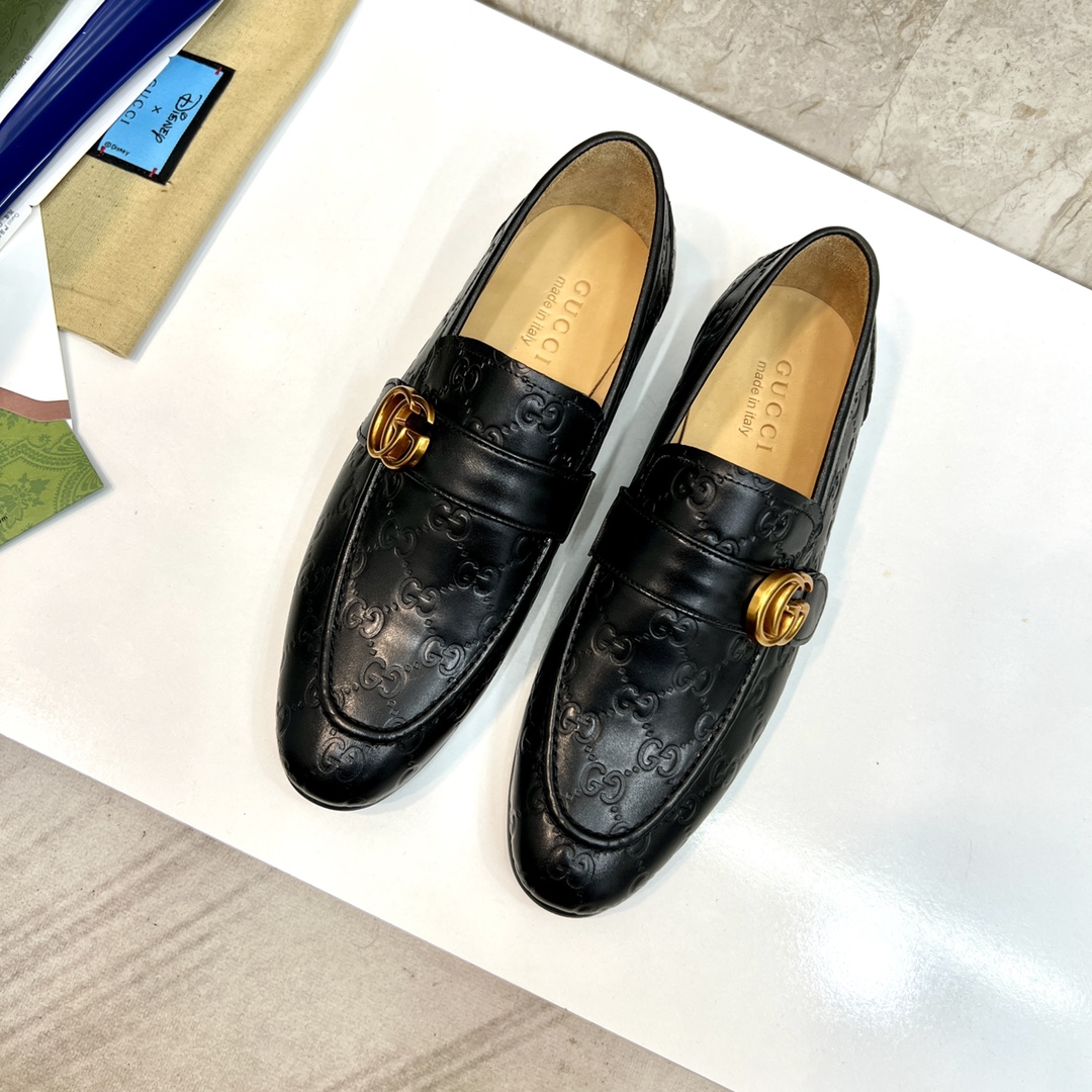 Gucci Men's Black Leather Loafers with Embossed GG Pattern and Gold Hardware