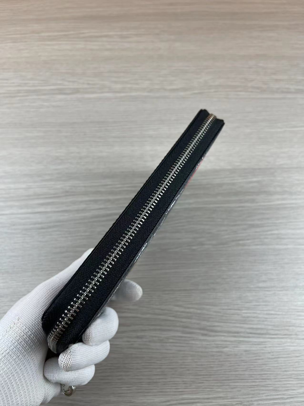 Close-up of zip around wallet zipper