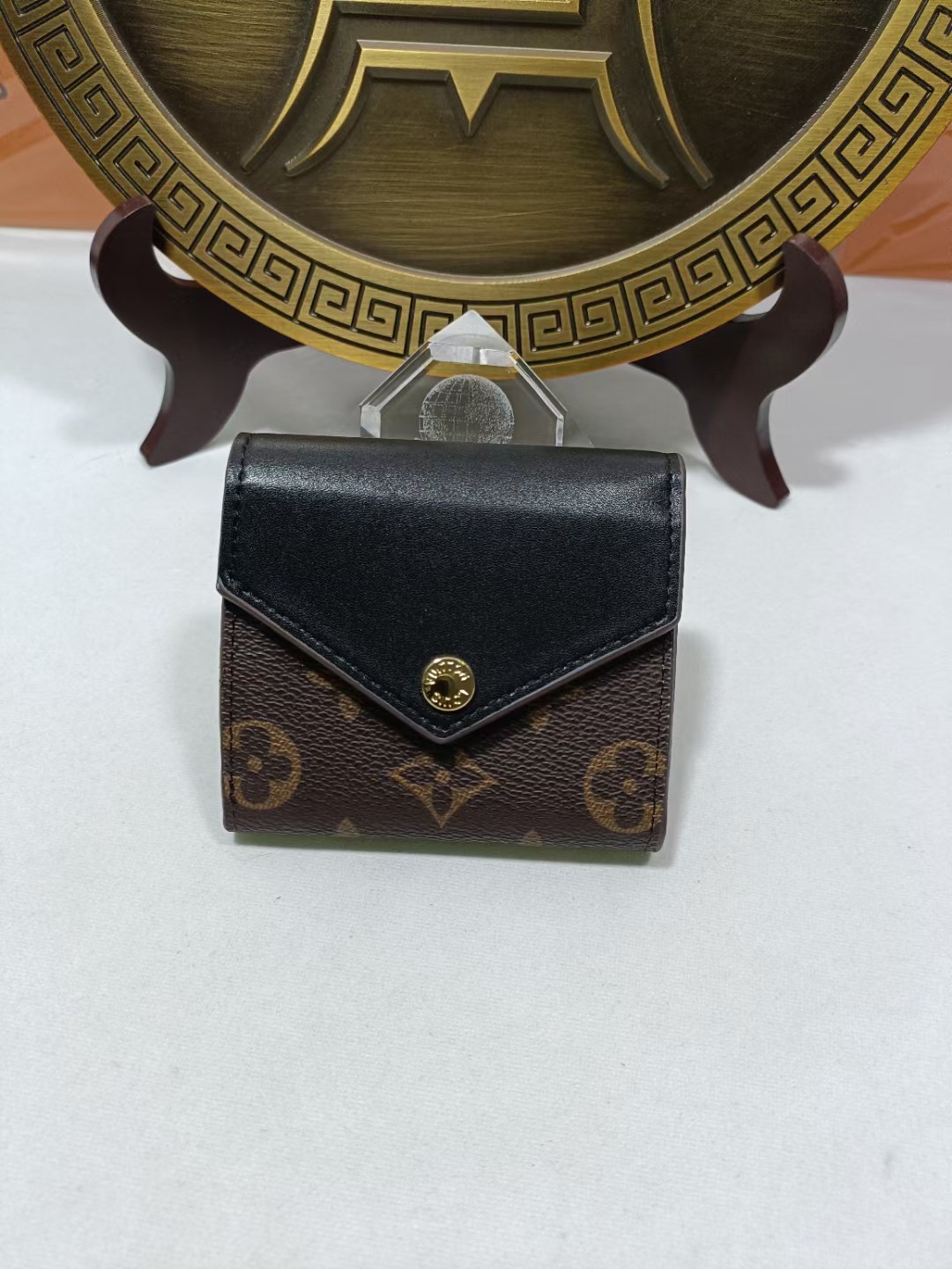 Genuine leather bifold wallet, front view, showing texture