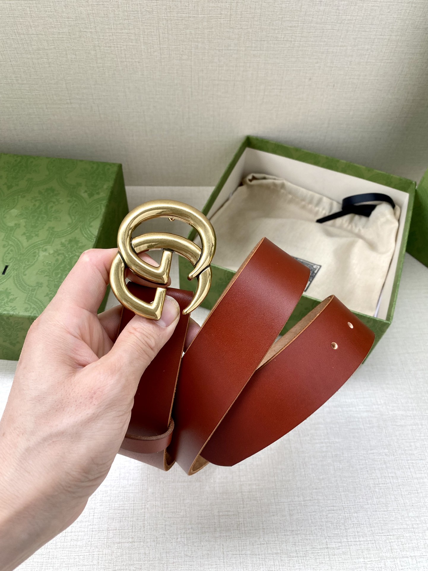 GUCCI单层树膏皮革腰带，配有品牌标志性双G带扣。无涂层褪色皮革材质。棕色皮革钯金色调配件双G带扣搭扣