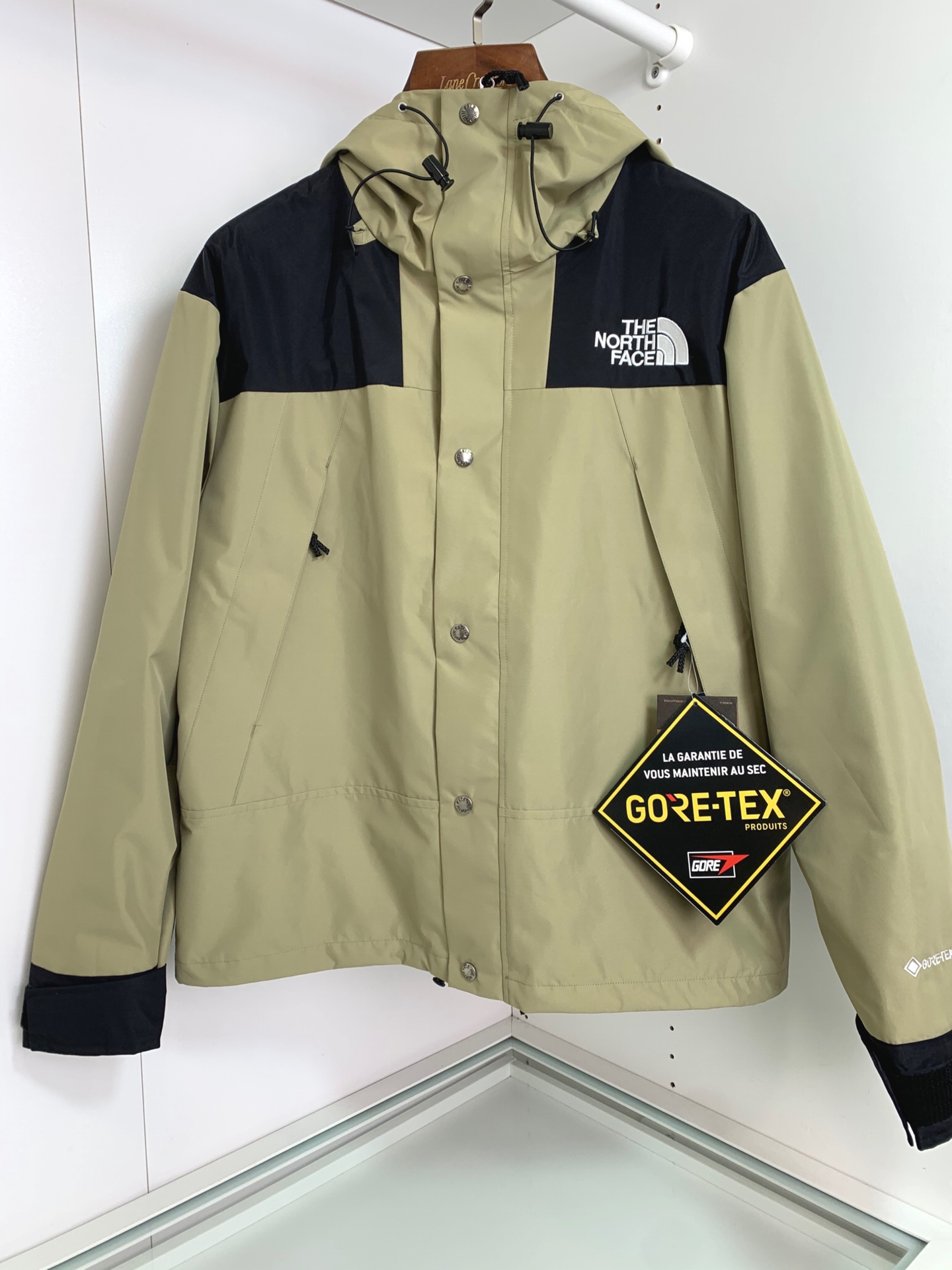 男士送礼精品 TNF 1990 Mountain Gore-Tex GTX冲锋衣 男女同款 TNF品牌1966年创立至今，其经典ICON产品如同一部部老电影，让人回味无穷。此次万众期待的mountain jacket 在1990年的原版基础上做了全面的升级 夹克面料选用防水材质 GORE-TEX2L配有塔夫绸和拉绒经编衬里 达到透气度与保暖度的高度结合 附加，可调节，腋下隐藏性拉链设计可透气调节。双中央正面防风罩采用按扣开合，VISLON中央正面拉链 反向进入高山口袋 可调节Velcro袖口标签 三个内袋 可调节下摆 兼容Zip-in 在胸部和背部的轭上绣上了NF徽标 前中VISLON拉链带以按扣和闭合的双层防风片 为户外活动提供全天候防风支持 配色方面承袭经典 以黑 白 为主 加持墨绿色 军绿色 抹茶绿 高辨度主色忠于原版撞色设计 尽显复古潮流 这次产品还有2方面的提升：1、防水为国际ISO标准90（ISO4）级别达到荷叶水珠滚动效果2、面料：高透层压织物Gore-tex仿水透气薄膜，手感更佳舒适。1990# 黑色 白色 墨绿色 军绿色 抹茶绿 S-XL， S码肩宽58胸围124衣长69袖长61； M码肩宽59胸围128衣长70袖长62； L码肩宽60胸围132衣长71袖长63； XL码肩宽61胸围136衣长72袖长64；