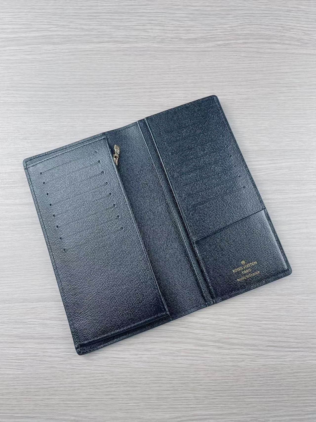 Leather bifold wallet with cards inserted into card slots.