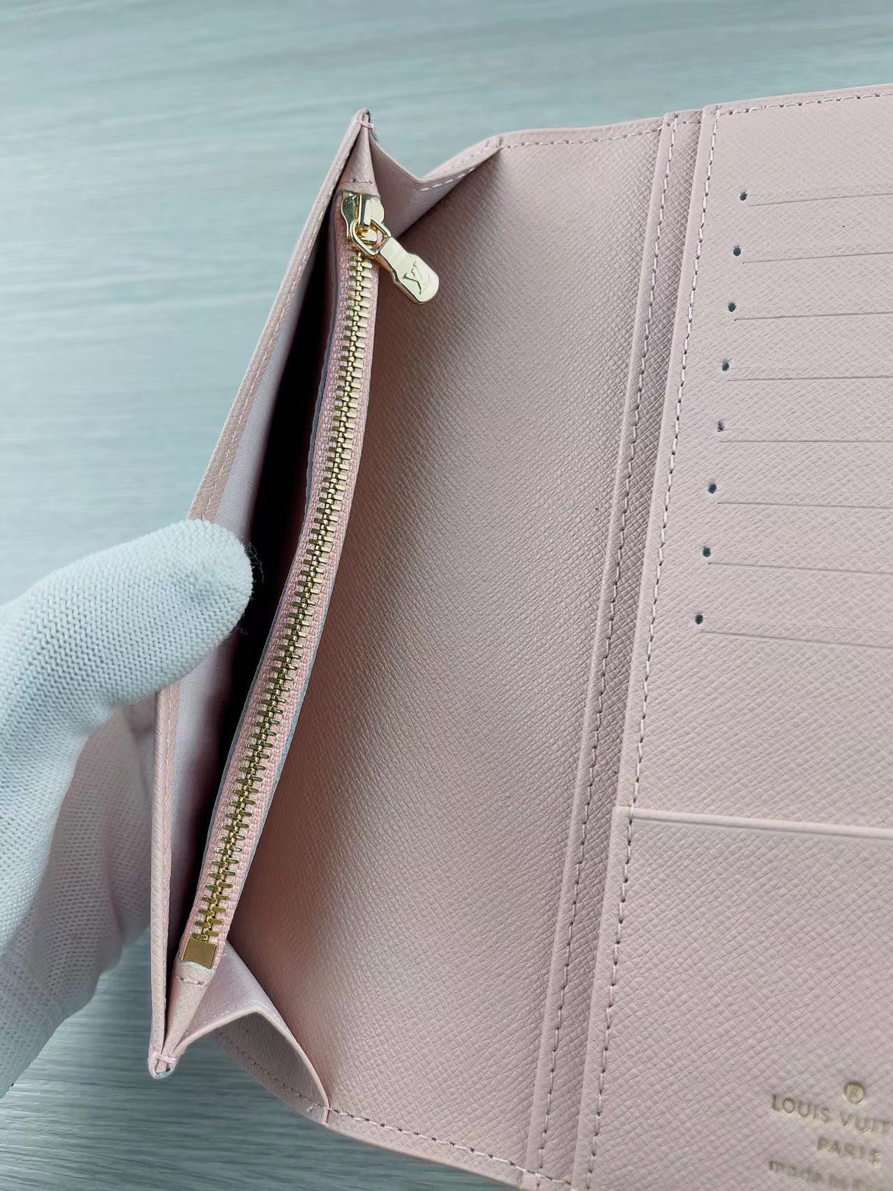 A closeup of the stitching on a leather bifold wallet