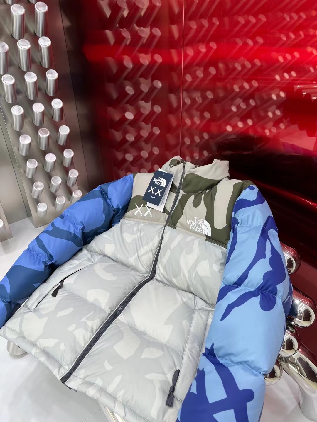 North Face x KAWS 1996 Nuptse jacket. New design with bold KAWS patterns and vibrant colors. Available in green and gray, sizes XS to XXL.-Big cat