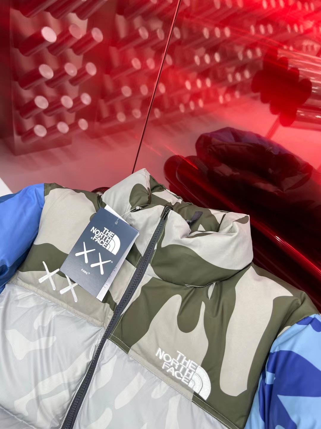 North Face x KAWS 1996 Nuptse jacket. New design with bold KAWS patterns and vibrant colors. Available in green and gray, sizes XS to XXL.-Big cat