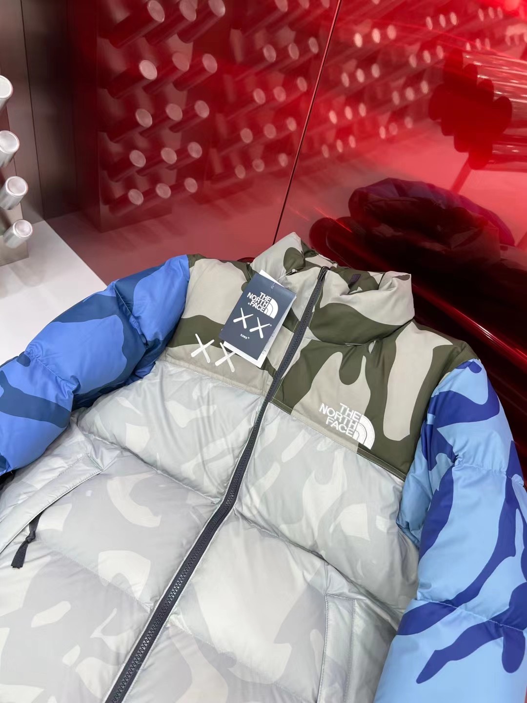 North Face x KAWS 1996 Nuptse jacket. New design with bold KAWS patterns and vibrant colors. Available in green and gray, sizes XS to XXL.-Big cat