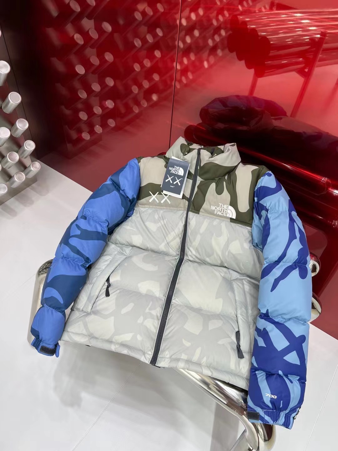 North Face x KAWS 1996 Nuptse jacket. New design with bold KAWS patterns and vibrant colors. Available in green and gray, sizes XS to XXL.-Big cat