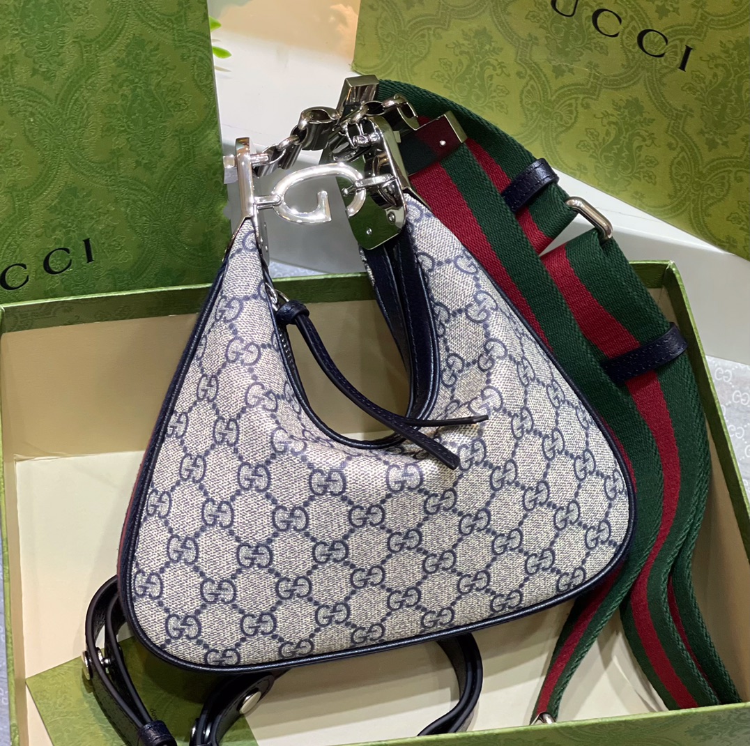 # Gucci Attache Series  
▫️ Model: 699409  
▫️ Size: 23*22*5 cm  

A standout piece that opens your style possibilities. This series offers multiple looks, crafted from genuine calf leather and PVC monogram, with custom premium hardware. The soft structure allows shape transformation—simply loosen the G-shaped clasp to switch between a half-moon or dumpling shape. Wear it as a shoulder bag, crossbody, or handbag with interchangeable leather and fabric straps, perfect for any occasion. image 1