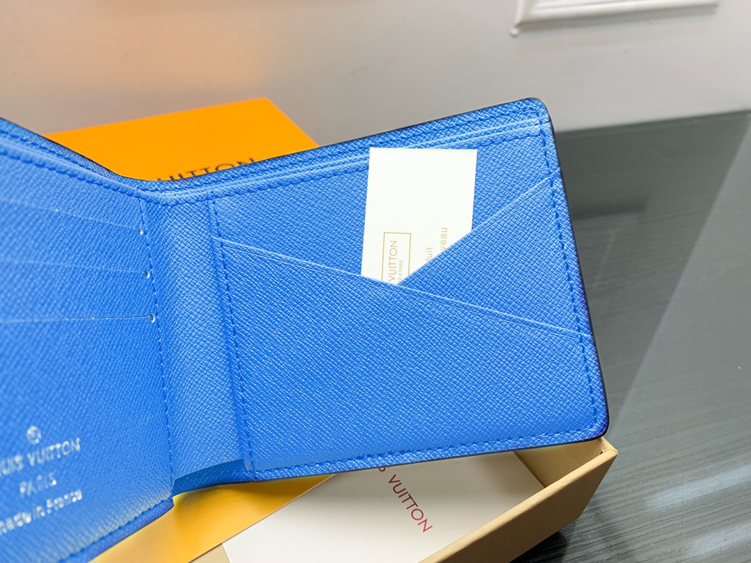 Leather bifold wallet next to a hand for comparison