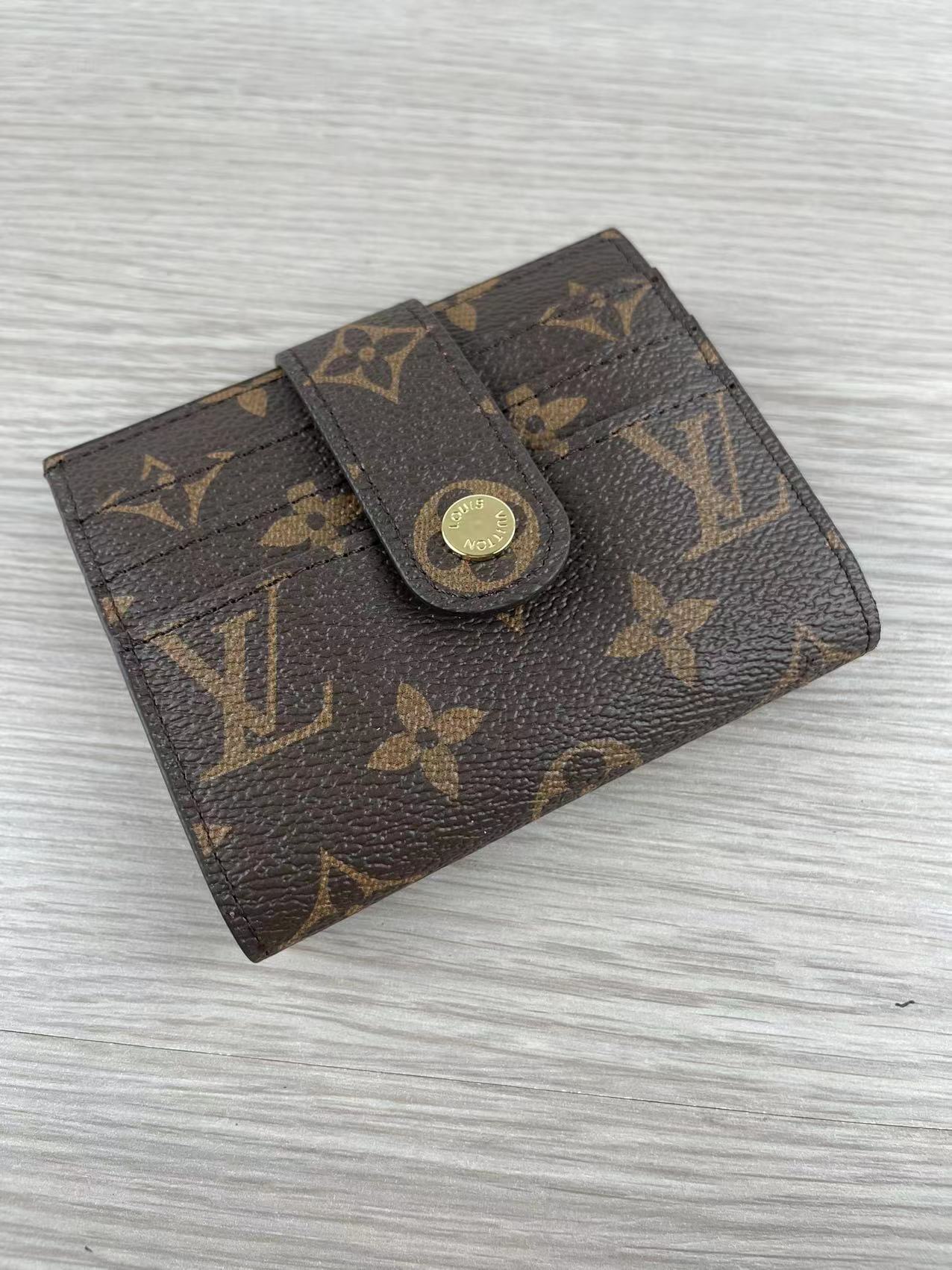 Open view of pink leather card holder showing card slots